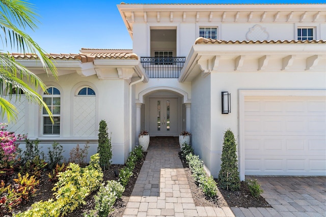 220 Carina Dr, Jupiter, FL 33478 - doorway to property with french doors, a balcony, stucco siding, and a garage