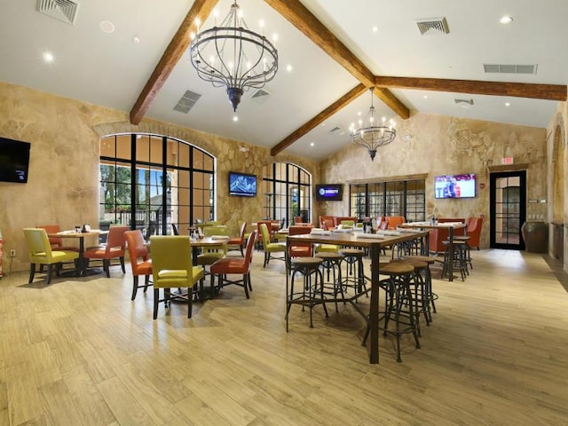 220 Carina Dr, Jupiter, FL 33478 - dining room with a chandelier, wood finished floors, beam ceiling, and high vaulted ceiling