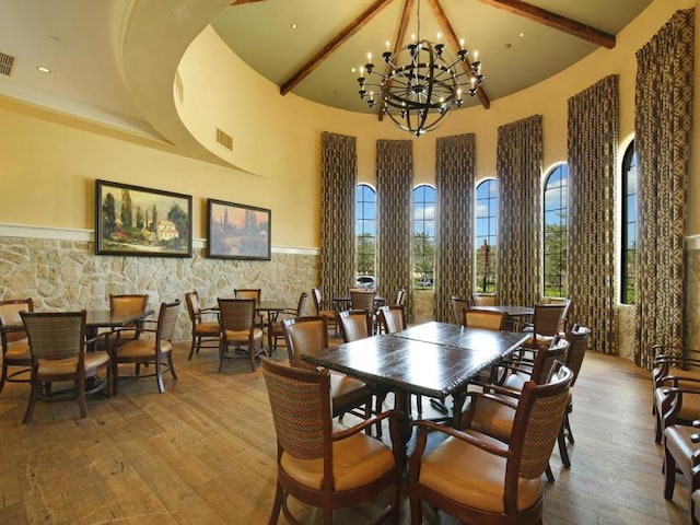 220 Carina Dr, Jupiter, FL 33478 - dining space with high vaulted ceiling, beam ceiling, hardwood / wood-style floors, a chandelier, and recessed lighting