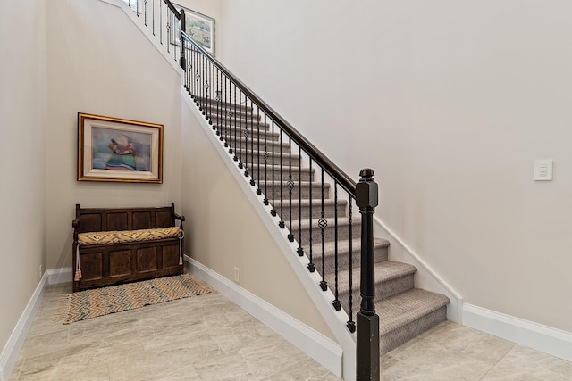 220 Carina Dr, Jupiter, FL 33478 - stairway featuring baseboards and a towering ceiling