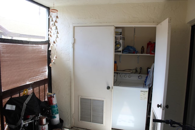 7609 Tahiti Ln Unit 201, Lake Worth, FL 33467 - laundry area with washer / dryer and a textured wall