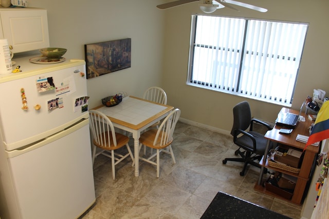 7609 Tahiti Ln Unit 201, Lake Worth, FL 33467 - dining room featuring a ceiling fan, baseboards, and an office area