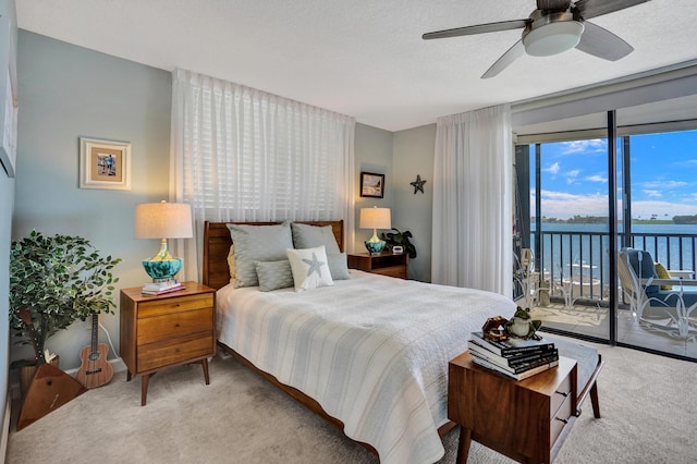 2424 N Federal Hwy Unit 315, Boynton Beach, FL 33435 - bedroom with carpet floors, access to exterior, a water view, ceiling fan, and a wall of windows