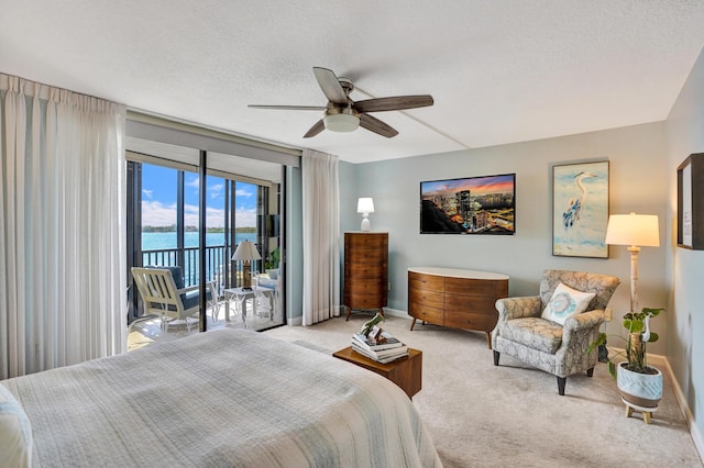 2424 N Federal Hwy Unit 315, Boynton Beach, FL 33435 - carpeted bedroom featuring access to outside, baseboards, a textured ceiling, and a ceiling fan