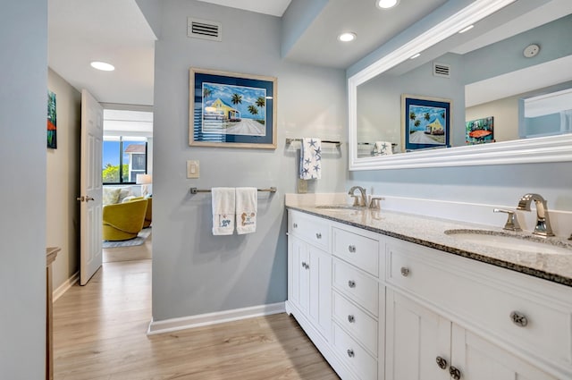 2424 N Federal Hwy Unit 315, Boynton Beach, FL 33435 - ensuite bathroom with double vanity, baseboards, wood finished floors, and recessed lighting