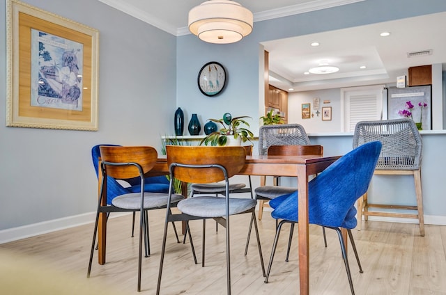 2424 N Federal Hwy Unit 315, Boynton Beach, FL 33435 - dining area with light wood finished floors, baseboards, crown molding, recessed lighting, and a raised ceiling