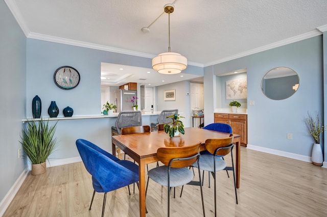 2424 N Federal Hwy Unit 315, Boynton Beach, FL 33435 - dining room featuring light wood-type flooring, baseboards, crown molding, and a textured ceiling