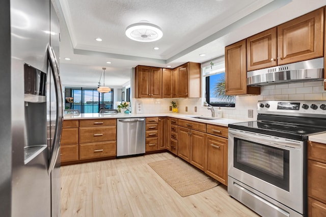 2424 N Federal Hwy Unit 315, Boynton Beach, FL 33435 - kitchen with appliances with stainless steel finishes, under cabinet range hood, brown cabinetry, a textured ceiling, and recessed lighting