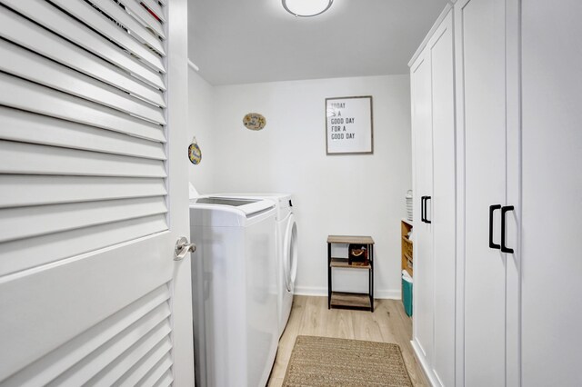 2424 N Federal Hwy Unit 315, Boynton Beach, FL 33435 - washroom with washing machine and dryer, light wood finished floors, and baseboards