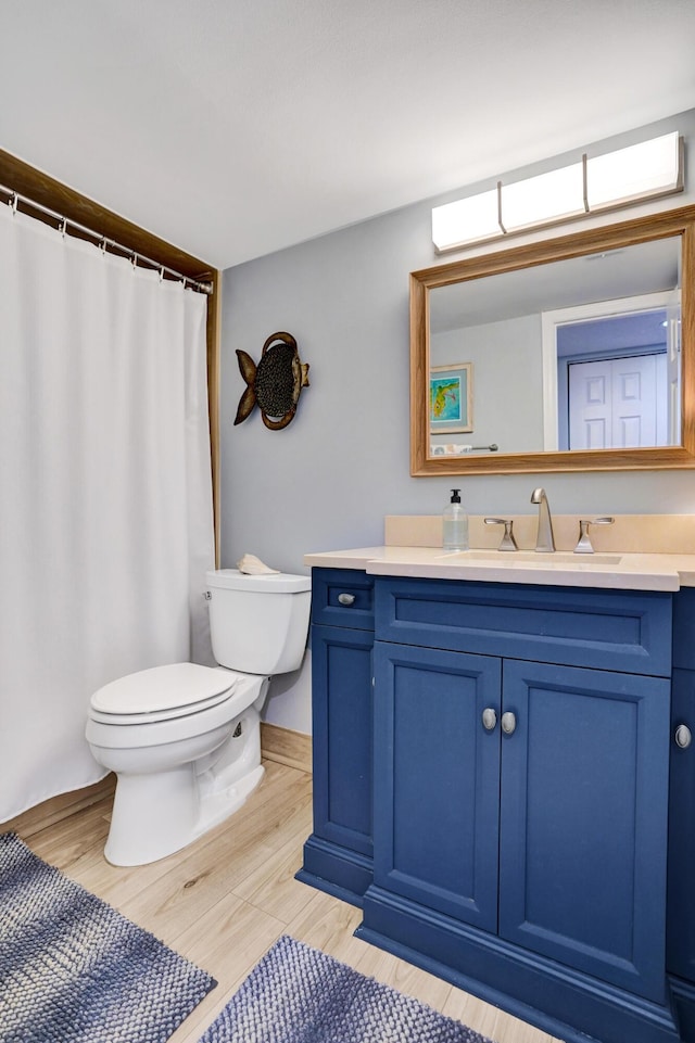 2424 N Federal Hwy Unit 315, Boynton Beach, FL 33435 - bathroom with toilet, vanity, and wood finished floors