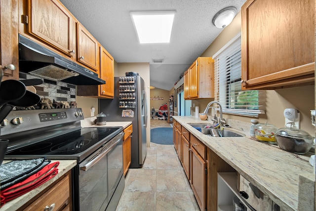 7201 N Blvd, Fort Pierce, FL 34951 - kitchen with stainless steel electric range, under cabinet range hood, a sink, a textured ceiling, and light stone finish flooring