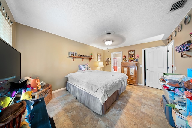 7201 N Blvd, Fort Pierce, FL 34951 - bedroom featuring a textured ceiling, baseboards, light stone finish flooring, connected bathroom, and a ceiling fan