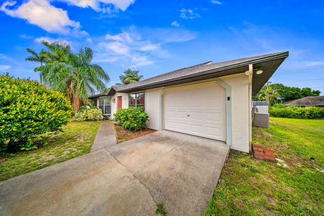 7201 N Blvd, Fort Pierce, FL 34951 - view of front facade with driveway, an attached garage, a front lawn, and stucco siding