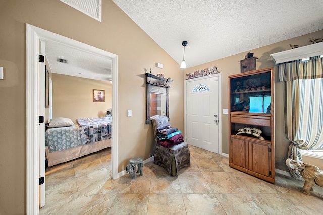 7201 N Blvd, Fort Pierce, FL 34951 - foyer entrance featuring a textured ceiling, lofted ceiling, stone tile flooring, and baseboards