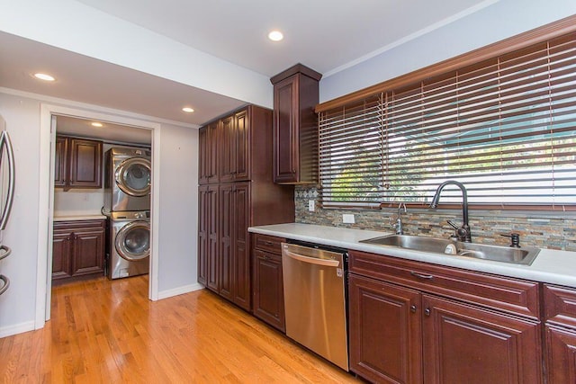 235 30th St, West Palm Beach, FL 33407 - kitchen with stacked washing machine and dryer, dishwasher, a sink, tasteful backsplash, and recessed lighting