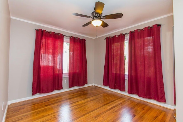235 30th St, West Palm Beach, FL 33407 - spare room with healthy amount of natural light, ceiling fan, wood finished floors, baseboards, and crown molding