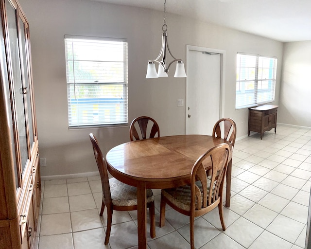 3026 Lincoln B 3026, Boca Raton, FL 33434 - dining room featuring light tile patterned floors, baseboards, and a chandelier