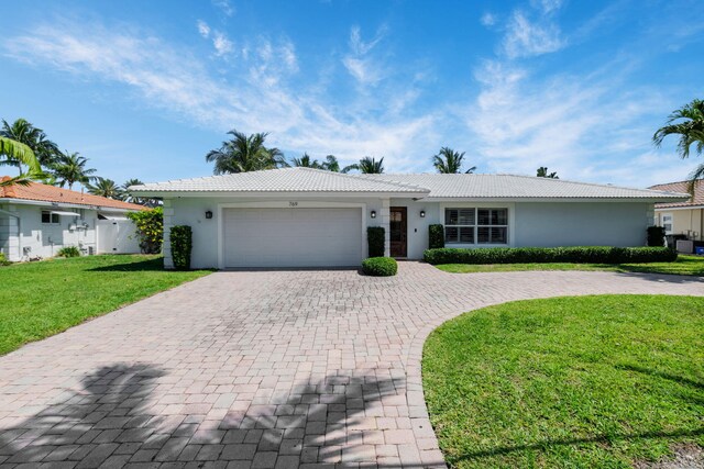 769 Berkeley St, Boca Raton, FL 33487 - ranch-style home featuring a garage, decorative driveway, stucco siding, and a tiled roof