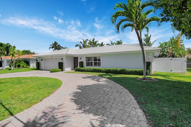 769 Berkeley St, Boca Raton, FL 33487 - ranch-style house featuring a tile roof, stucco siding, an attached garage, driveway, and a gate
