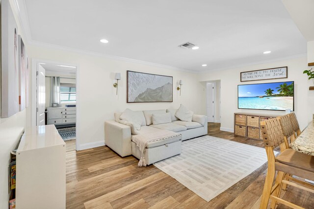 769 Berkeley St, Boca Raton, FL 33487 - living room featuring crown molding, light wood finished floors, baseboards, and recessed lighting