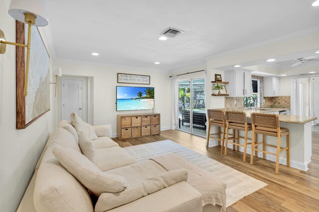 769 Berkeley St, Boca Raton, FL 33487 - living area featuring crown molding, recessed lighting, light wood-style flooring, baseboards, and a ceiling fan
