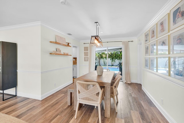 769 Berkeley St, Boca Raton, FL 33487 - dining space with light wood-type flooring, crown molding, and baseboards