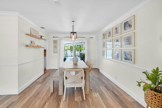 769 Berkeley St, Boca Raton, FL 33487 - dining space with light wood finished floors, ornamental molding, and baseboards