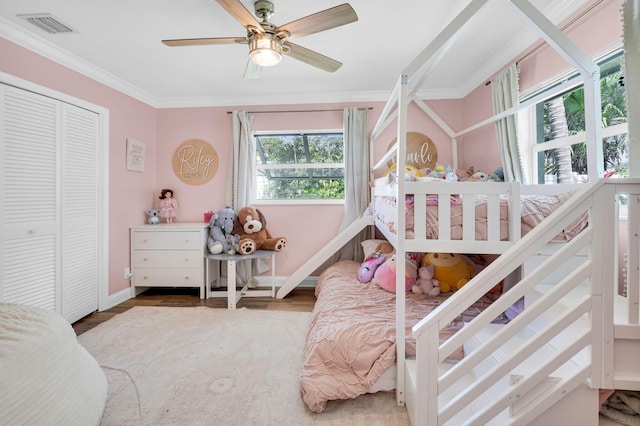 769 Berkeley St, Boca Raton, FL 33487 - bedroom featuring crown molding, baseboards, a ceiling fan, wood finished floors, and a closet