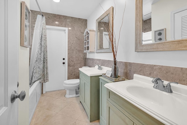 769 Berkeley St, Boca Raton, FL 33487 - bathroom with tile walls, two vanities, toilet, tile patterned flooring, and shower / tub combo with curtain