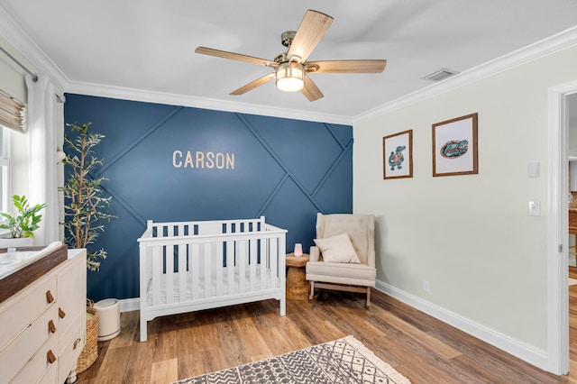 769 Berkeley St, Boca Raton, FL 33487 - bedroom featuring crown molding, baseboards, a crib, wood finished floors, and a ceiling fan