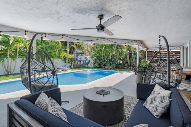 769 Berkeley St, Boca Raton, FL 33487 - view of swimming pool featuring a ceiling fan, an outdoor hangout area, a fenced backyard, and a patio