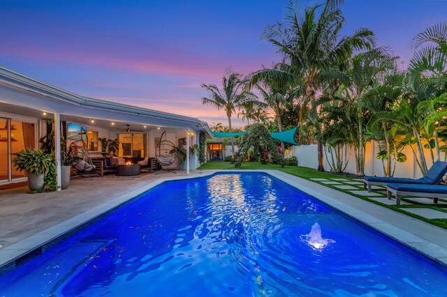 769 Berkeley St, Boca Raton, FL 33487 - pool at dusk with a patio, outdoor lounge area, an outdoor pool, and a ceiling fan