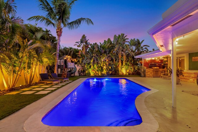 769 Berkeley St, Boca Raton, FL 33487 - outdoor pool featuring an outdoor kitchen, a patio area, and a fenced backyard