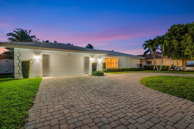 769 Berkeley St, Boca Raton, FL 33487 - ranch-style home featuring curved driveway, an attached garage, and stucco siding
