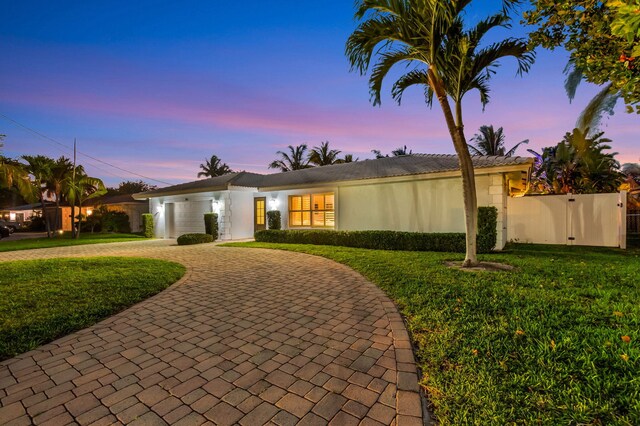 769 Berkeley St, Boca Raton, FL 33487 - view of front of home featuring curved driveway, a garage, and stucco siding