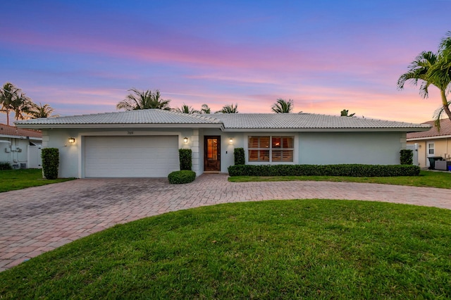 769 Berkeley St, Boca Raton, FL 33487 - ranch-style home with stucco siding, decorative driveway, a garage, and a yard