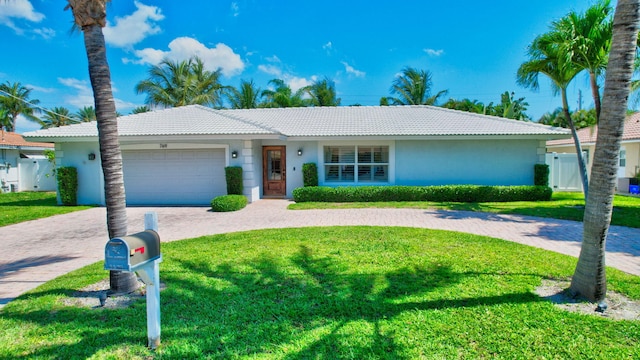 769 Berkeley St, Boca Raton, FL 33487 - single story home featuring a tile roof, stucco siding, a garage, and decorative driveway