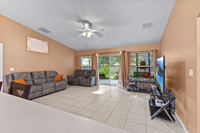 3182 SW Cathedral St, Port Saint Lucie, FL 34953 - living area featuring vaulted ceiling, light tile patterned flooring, and ceiling fan