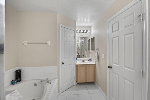 3182 SW Cathedral St, Port Saint Lucie, FL 34953 - bathroom featuring a garden tub, vanity, tile patterned flooring, a textured ceiling, and baseboards