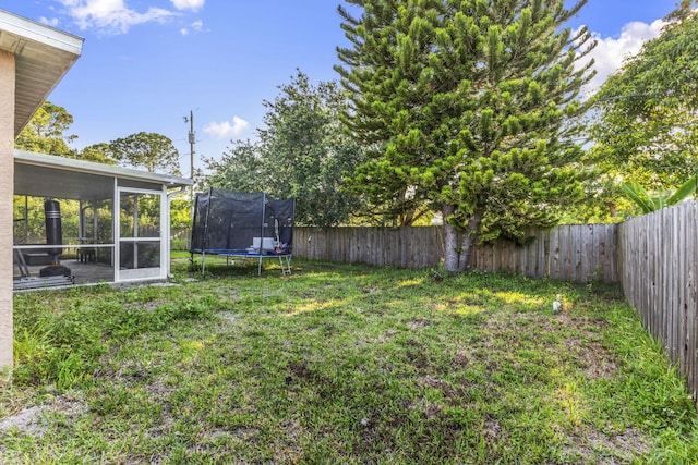 3182 SW Cathedral St, Port Saint Lucie, FL 34953 - view of yard featuring a trampoline and a sunroom