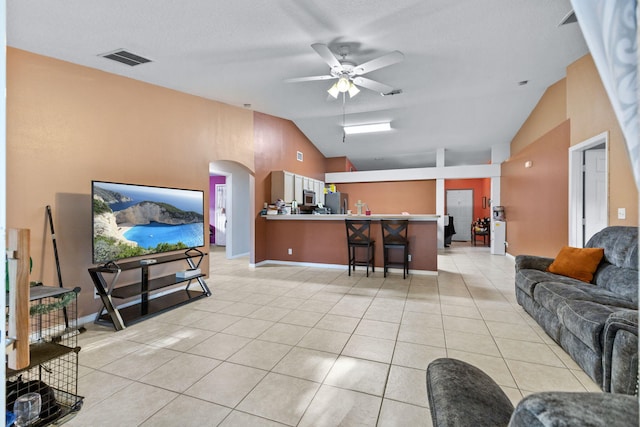 3182 SW Cathedral St, Port Saint Lucie, FL 34953 - living area with a ceiling fan, light tile patterned flooring, arched walkways, and high vaulted ceiling