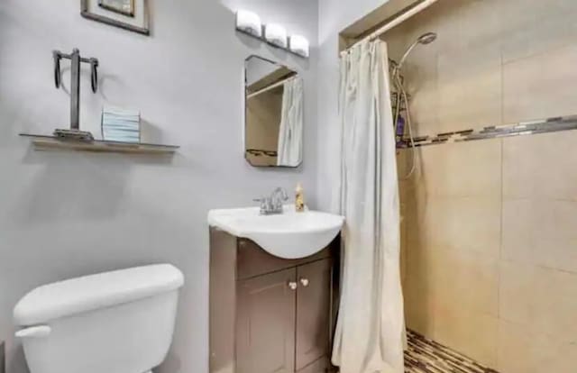 3093 SW Berry Ave, Palm City, FL 34990 - full bath featuring vanity, tiled shower, and toilet