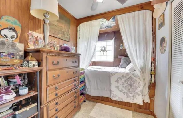 3093 SW Berry Ave, Palm City, FL 34990 - bedroom with wooden walls, a closet, and ceiling fan