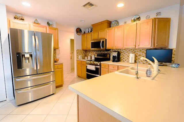 4245 Bluff Harbor Way, Wellington, FL 33449 - kitchen featuring stainless steel appliances, a sink, light brown cabinets, light countertops, and decorative backsplash