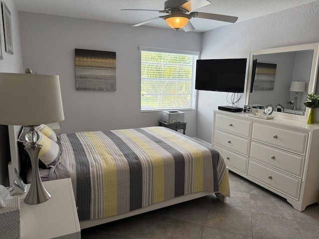 478 Capri J, Delray Beach, FL 33484 - bedroom featuring a textured wall, tile patterned flooring, and a ceiling fan