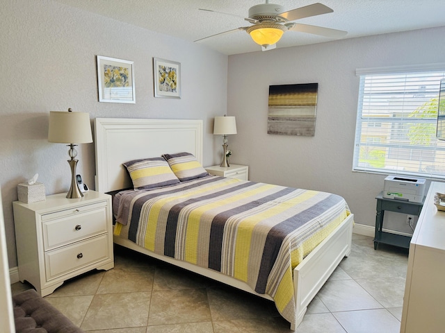 478 Capri J, Delray Beach, FL 33484 - bedroom featuring light tile patterned floors, ceiling fan, and a textured ceiling