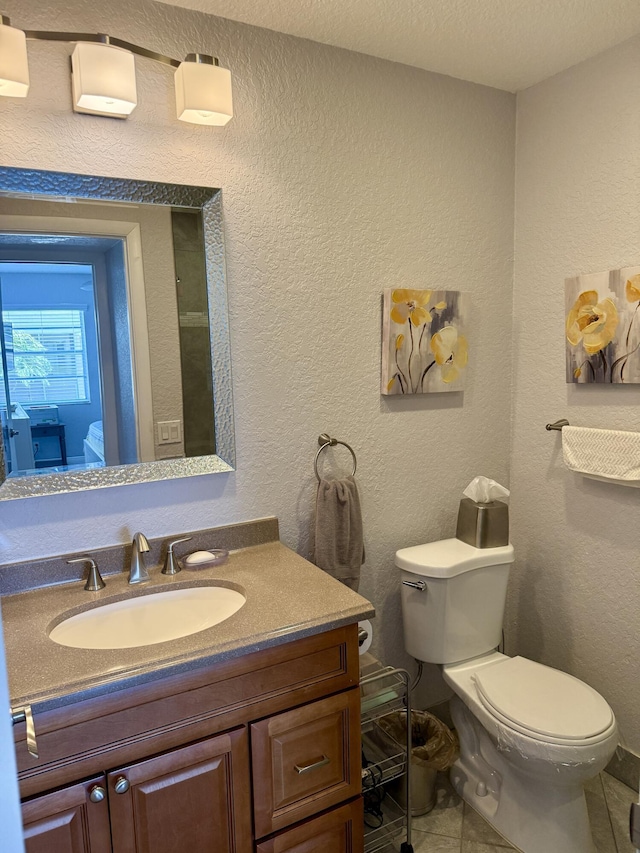 478 Capri J, Delray Beach, FL 33484 - half bathroom featuring toilet, tile patterned floors, vanity, and a textured wall