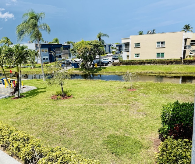 478 Capri J, Delray Beach, FL 33484 - surrounding community featuring a water view, a lawn, and a residential view