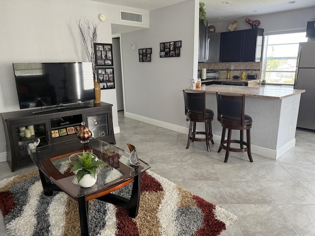 478 Capri J, Delray Beach, FL 33484 - living room featuring baseboards
