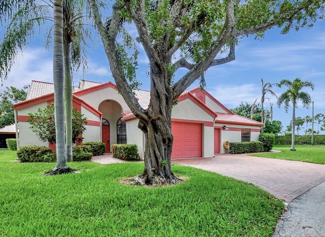 7644 Lexington Club Blvd Unit A, Delray Beach, FL 33446 - mediterranean / spanish home with an attached garage, stucco siding, a front lawn, driveway, and a tiled roof